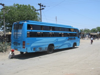 Broken down bus examined by man in turba