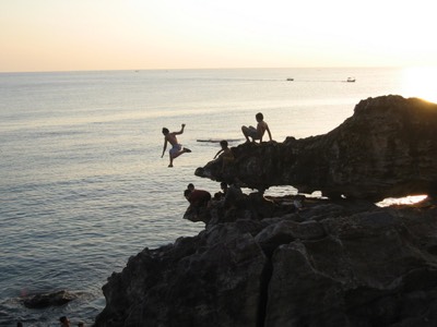 Local kids jumping off rocks
