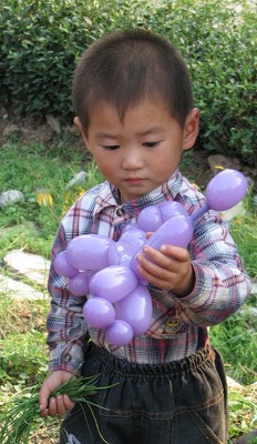 Longjing boy with balloon animal