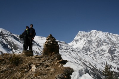 Posing on hill overlooking mountains